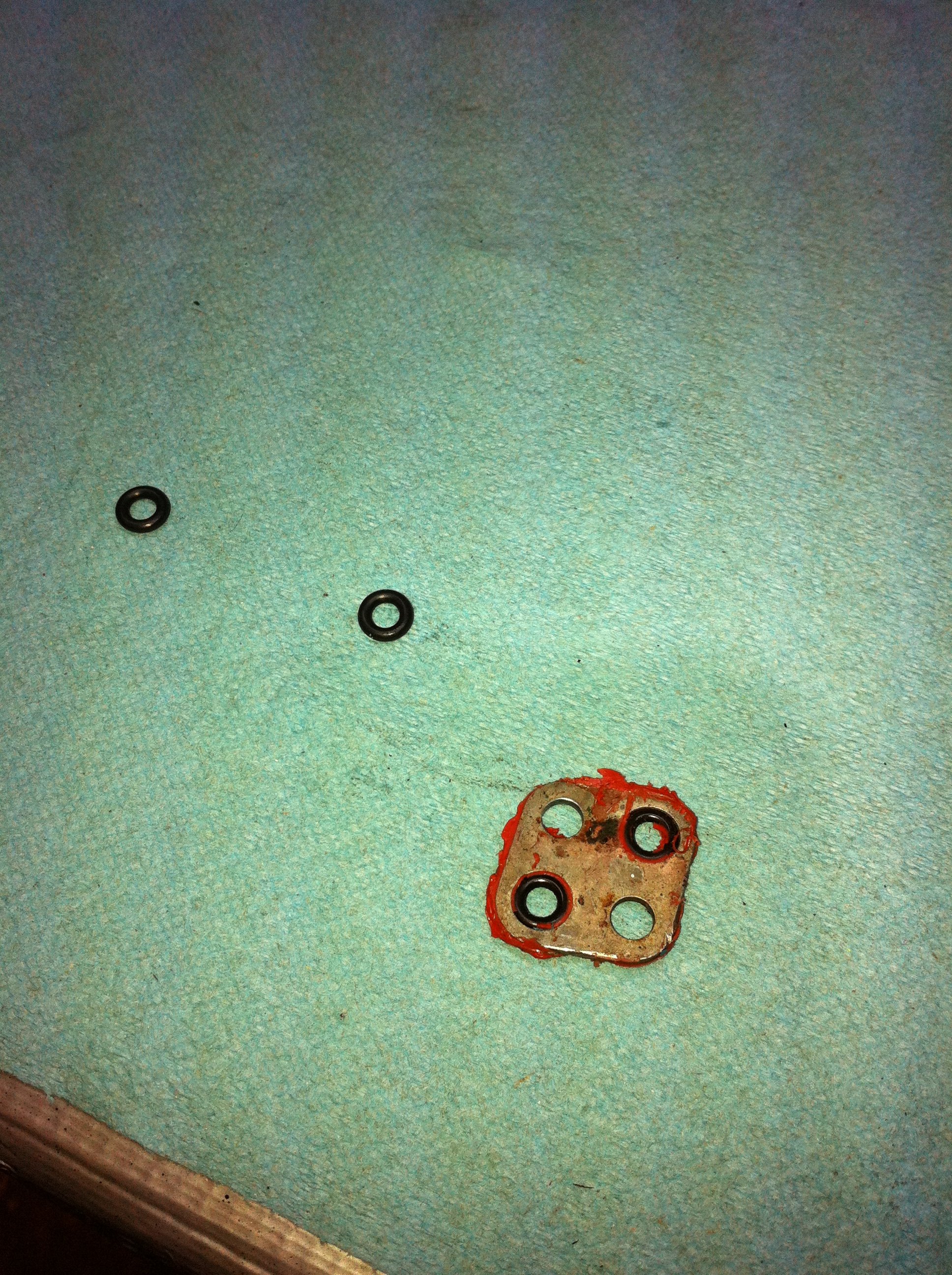 Steering rack o-rings had red RTV goop slathered on them, plugging one of the holes in the rack