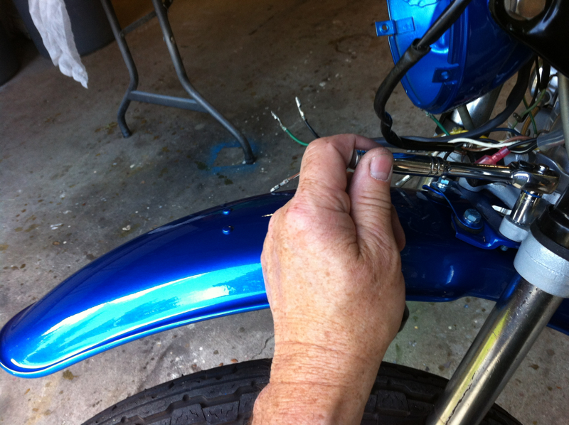 Installing the fender with new bolts and washers and nuts