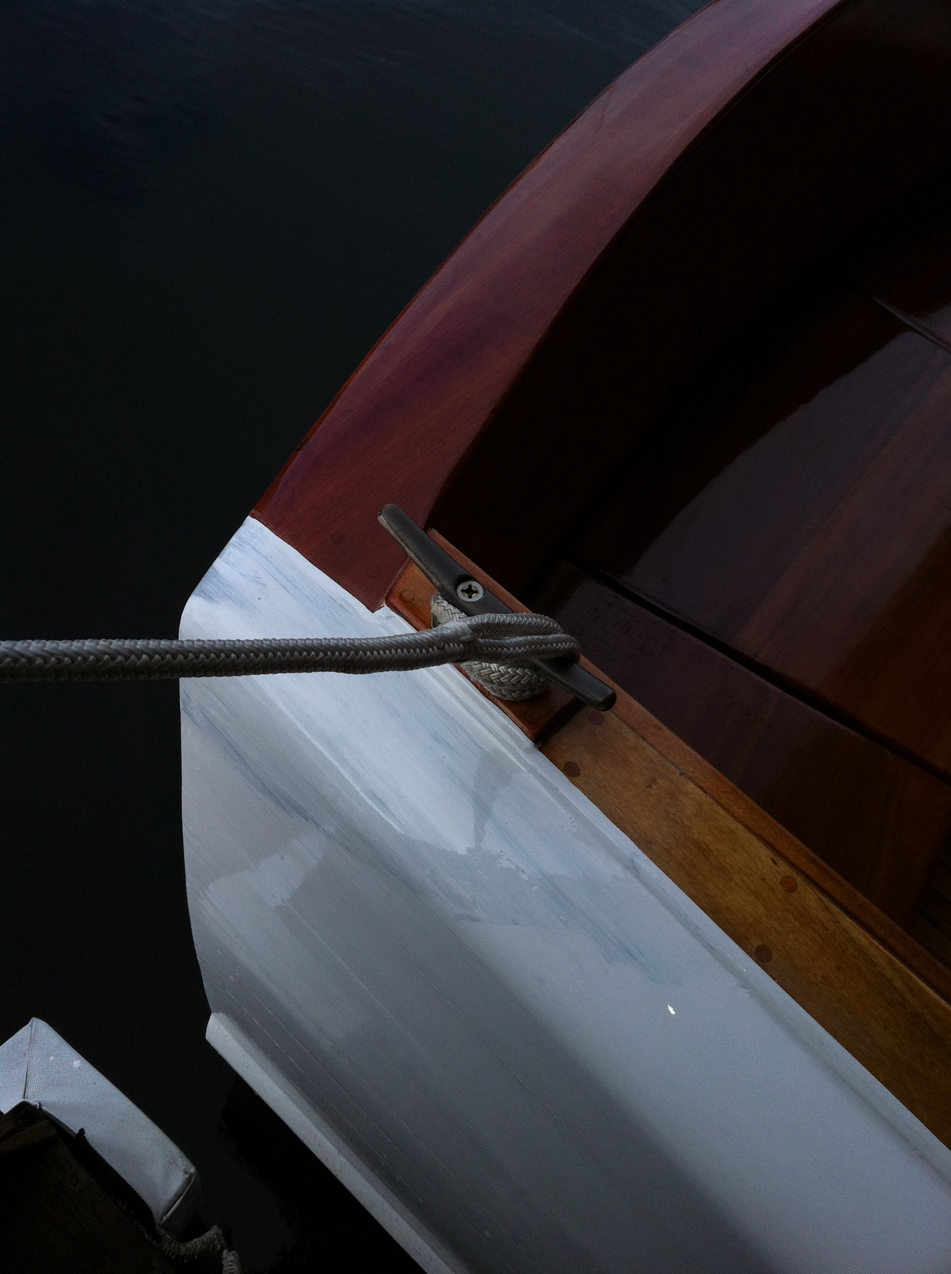 I do some touch-up on the aft gunwales where I had faired the new transom cap wood into the rounded gunwales.